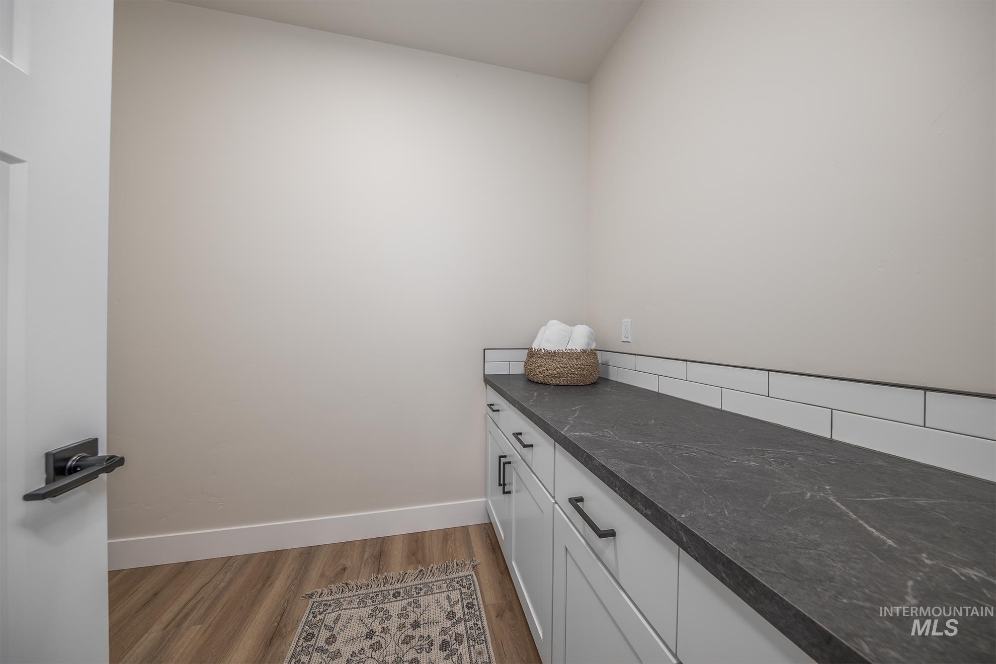1367 Hansen Road Weiser, ID 83672 - Photo 21 of 36 Laundry area featuring baseboards and light wood-style flooring