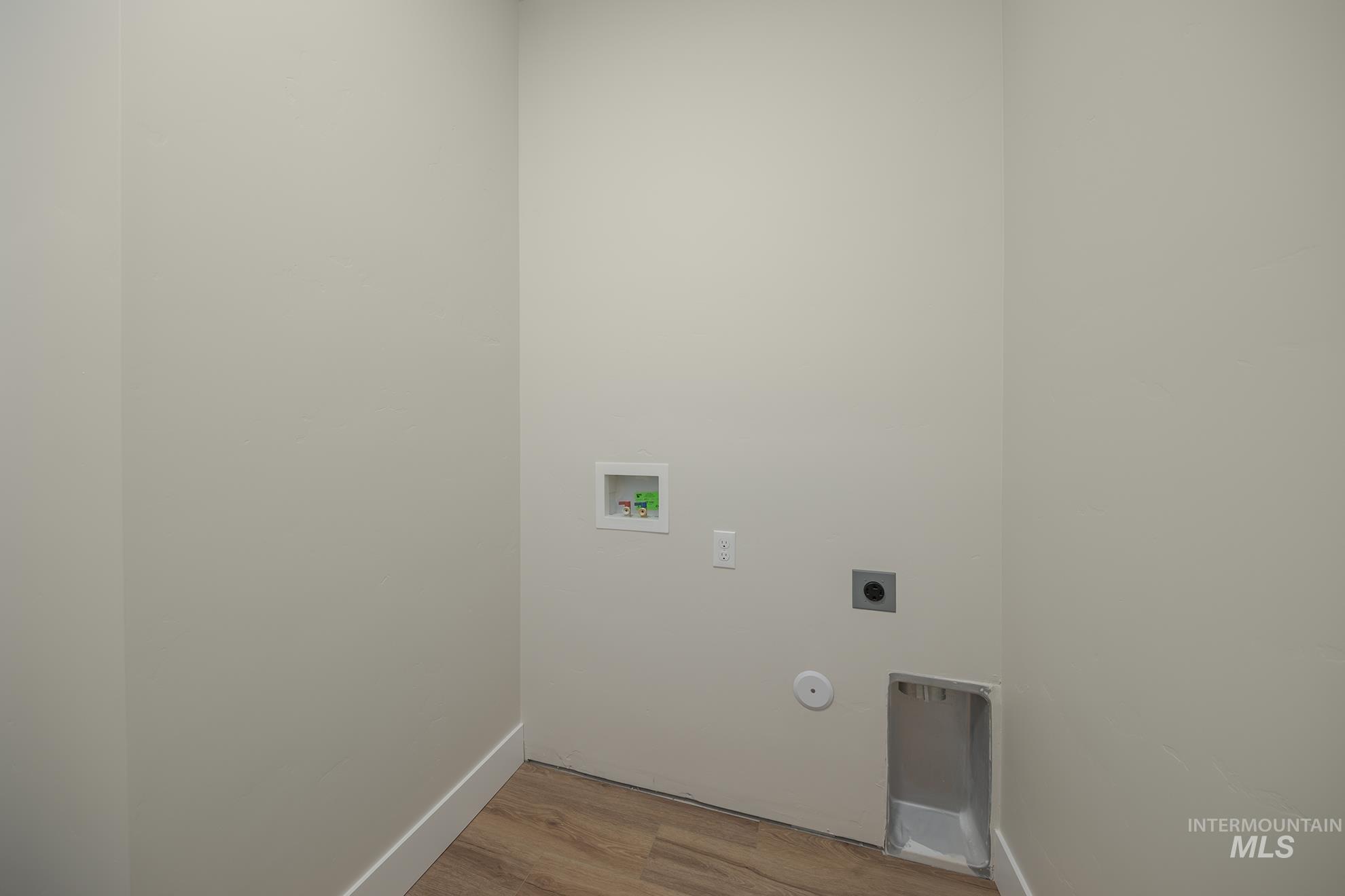 1367 Hansen Road Weiser, ID 83672 - Photo 22 of 36 Laundry area featuring hookup for a washing machine, light wood finished floors, and hookup for an electric dryer