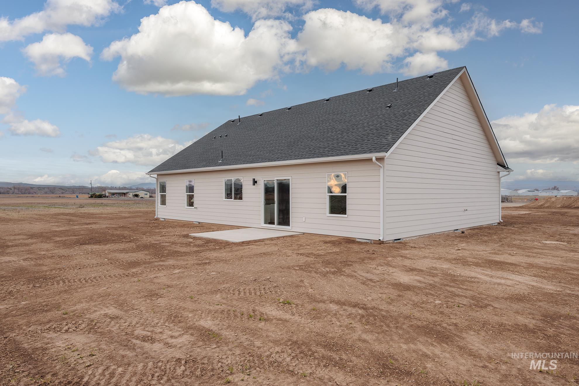 1367 Hansen Road Weiser, ID 83672 - Photo 28 of 36 Rear view of house with a patio and a shingled roof