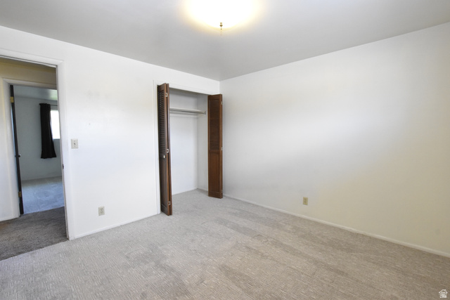 290 West 600 North Logan, UT 84321 - Photo 33 of 45 Carpeted room featuring a built-in closet with bi-fold louvered doors