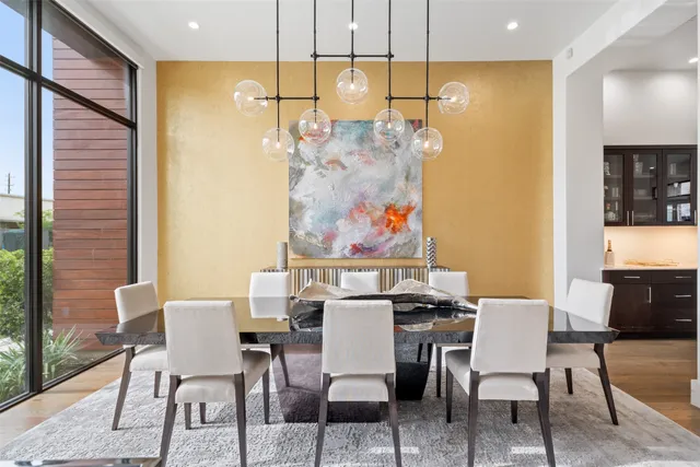a living room with furniture kitchen view and a chandelier
