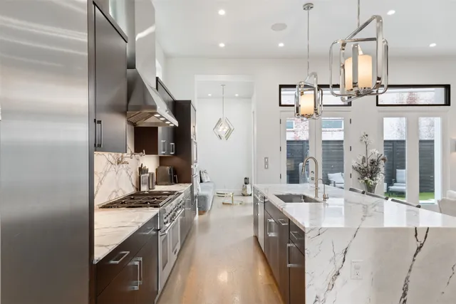a bedroom with a large bed and a chandelier