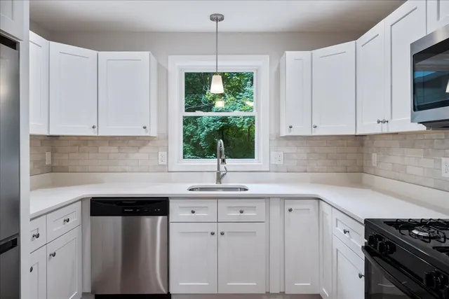 a kitchen with a sink stove and microwave
