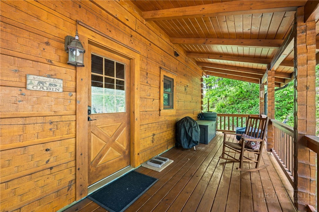 613 Silas Creek Road Lansing, NC 28643 - Photo 26 of 40 a view of a balcony with chairs and wooden floor