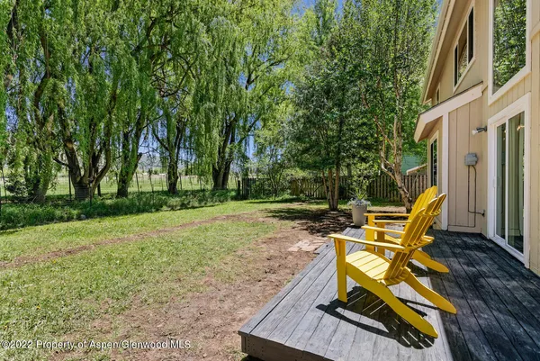 a view of a backyard with sitting area