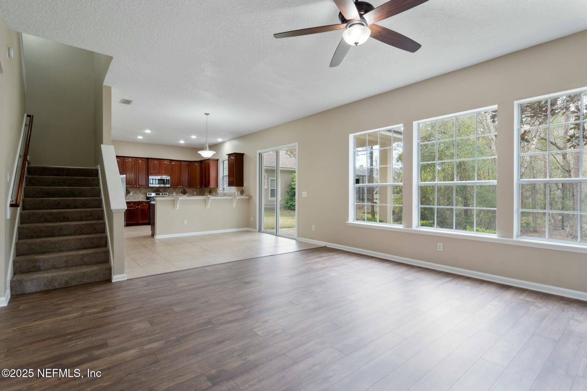 2448 Country Side Drive Fleming Island, FL 32003 - Photo 5 of 46 a view of an entryway with wooden floor and a ceiling fan