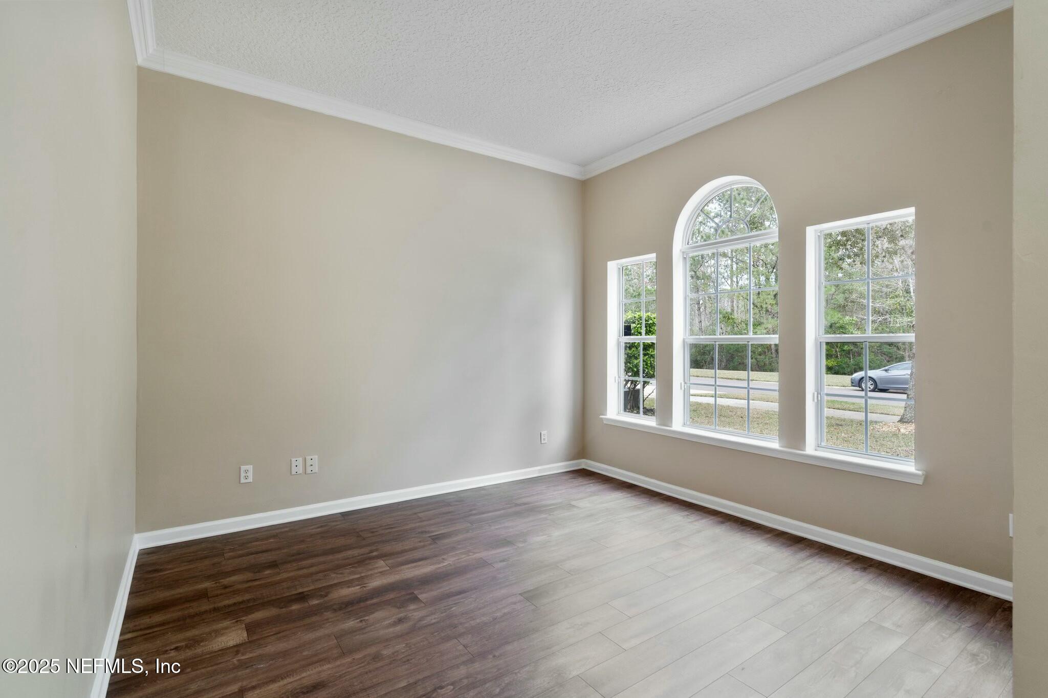 2448 Country Side Drive Fleming Island, FL 32003 - Photo 7 of 46 a view of an empty room with wooden floor and a window