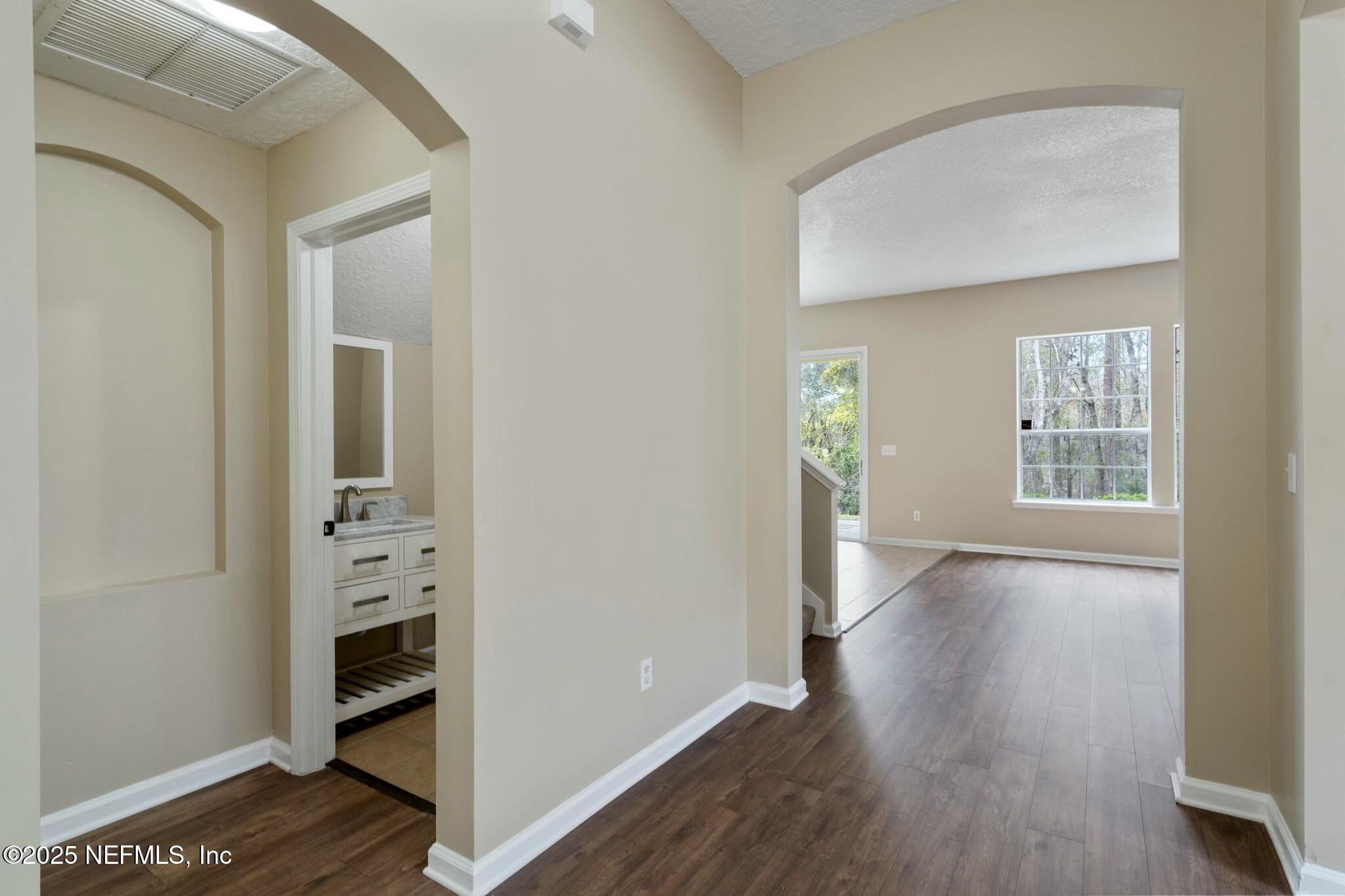 2448 Country Side Drive Fleming Island, FL 32003 - Photo 9 of 46 an empty room with wooden floor closet and windows
