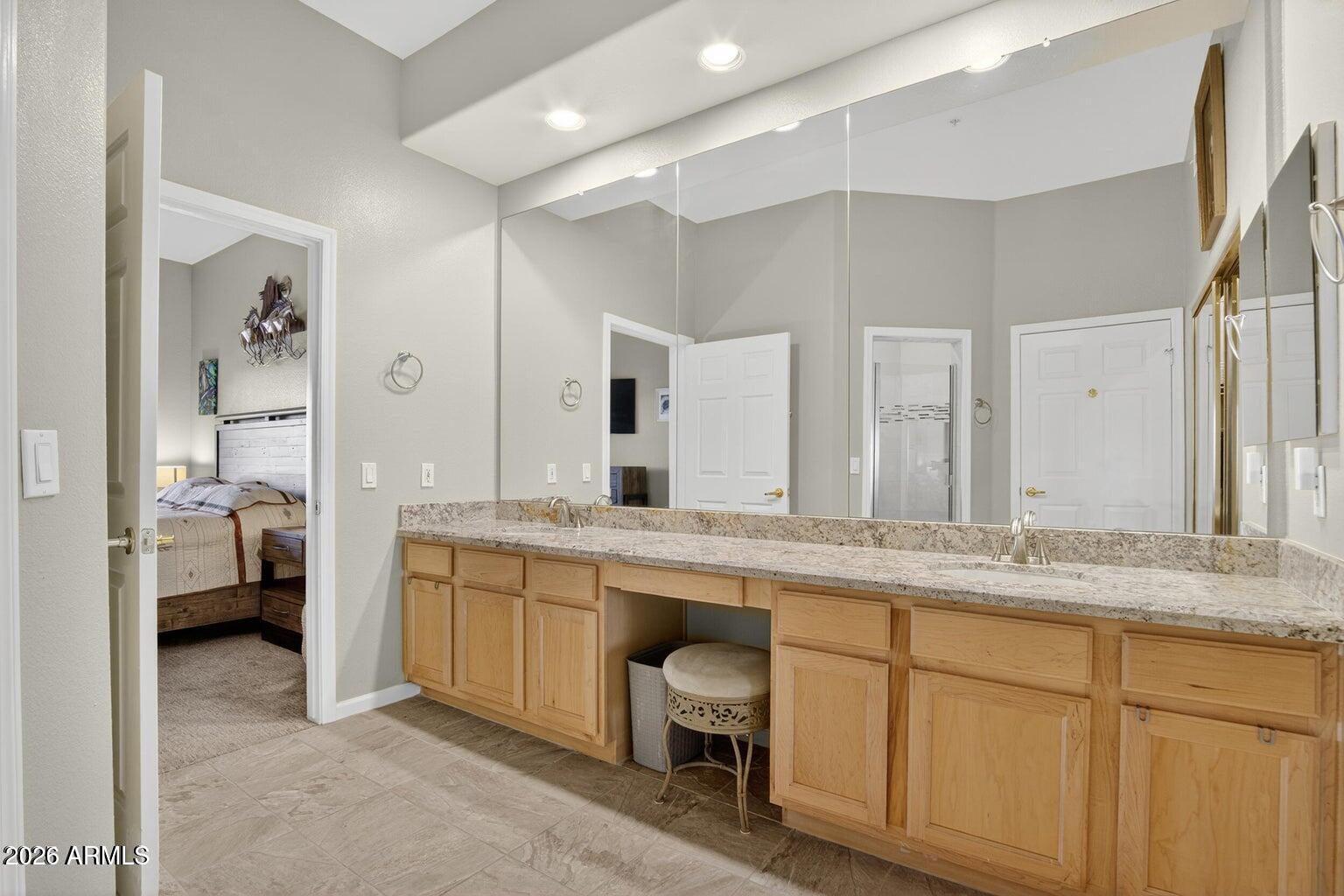 8245 East Bell Road, Unit 121 Scottsdale, AZ 85260 - Photo 12 of 22 a spacious bathroom with a granite countertop sink mirror and bathtub