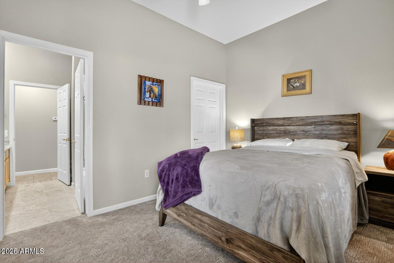 8245 East Bell Road, Unit 121 Scottsdale, AZ 85260 - Photo 16 of 22 a bedroom with a bed and a view of kitchen