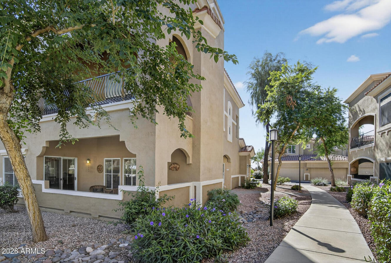 8245 East Bell Road, Unit 121 Scottsdale, AZ 85260 - Photo 2 of 22 a view of a house with a garden