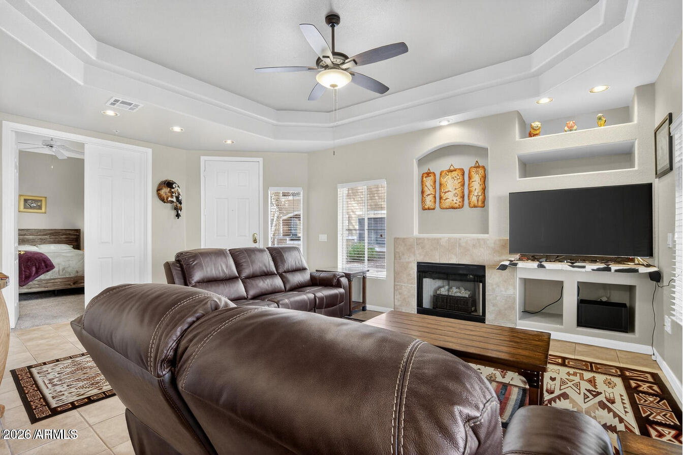 8245 East Bell Road, Unit 121 Scottsdale, AZ 85260 - Photo 3 of 22 a spacious bedroom with a bed and a fireplace