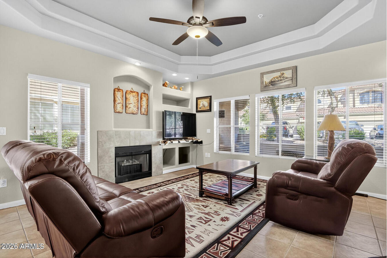 8245 East Bell Road, Unit 121 Scottsdale, AZ 85260 - Photo 4 of 22 a living room with furniture fireplace and a large window