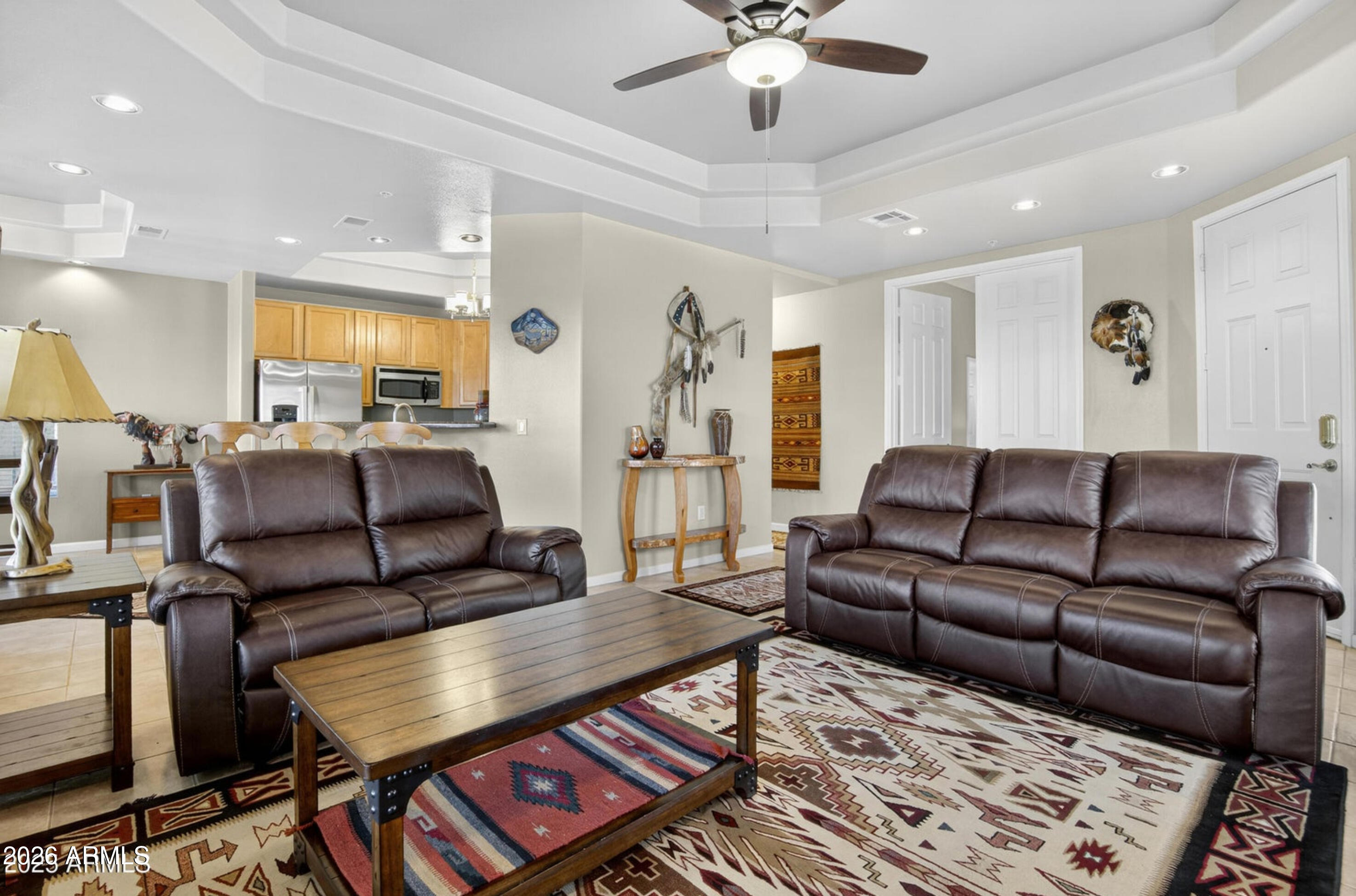 8245 East Bell Road, Unit 121 Scottsdale, AZ 85260 - Photo 5 of 22 a living room with furniture and a chandelier