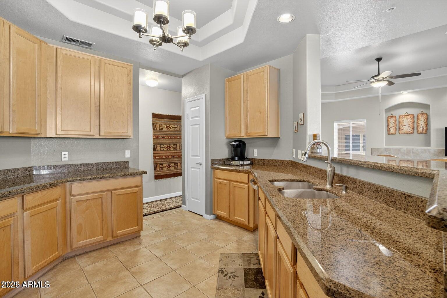 8245 East Bell Road, Unit 121 Scottsdale, AZ 85260 - Photo 8 of 22 a kitchen with a stove refrigerator sink and cabinets