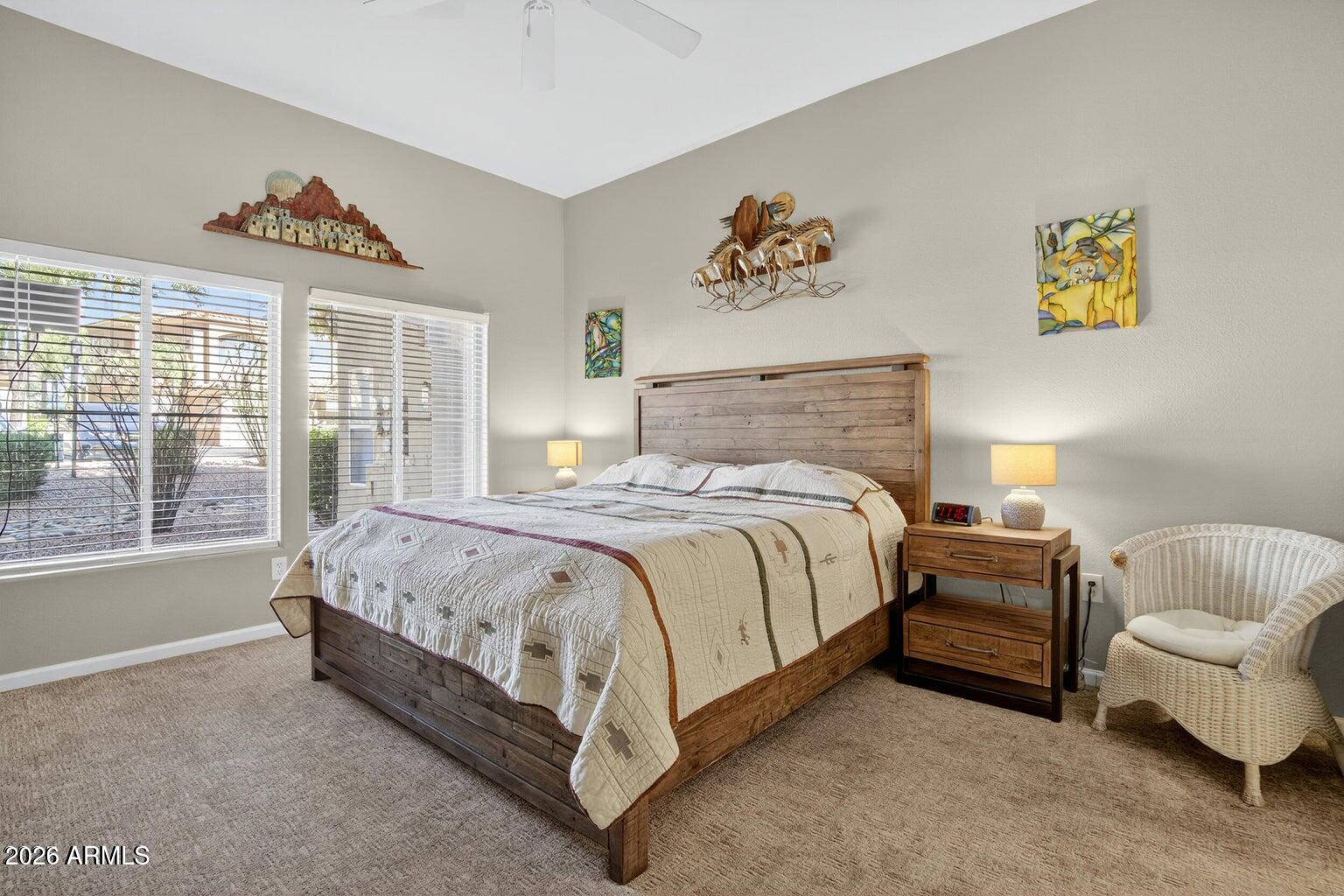 8245 East Bell Road, Unit 121 Scottsdale, AZ 85260 - Photo 10 of 22 a spacious bedroom with a bed and a couch