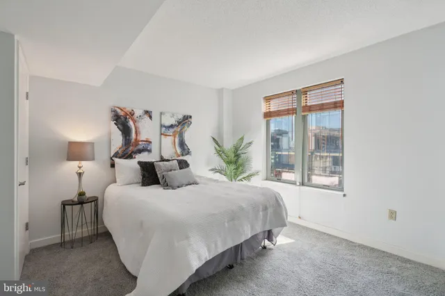 a bedroom with a large bed and a window