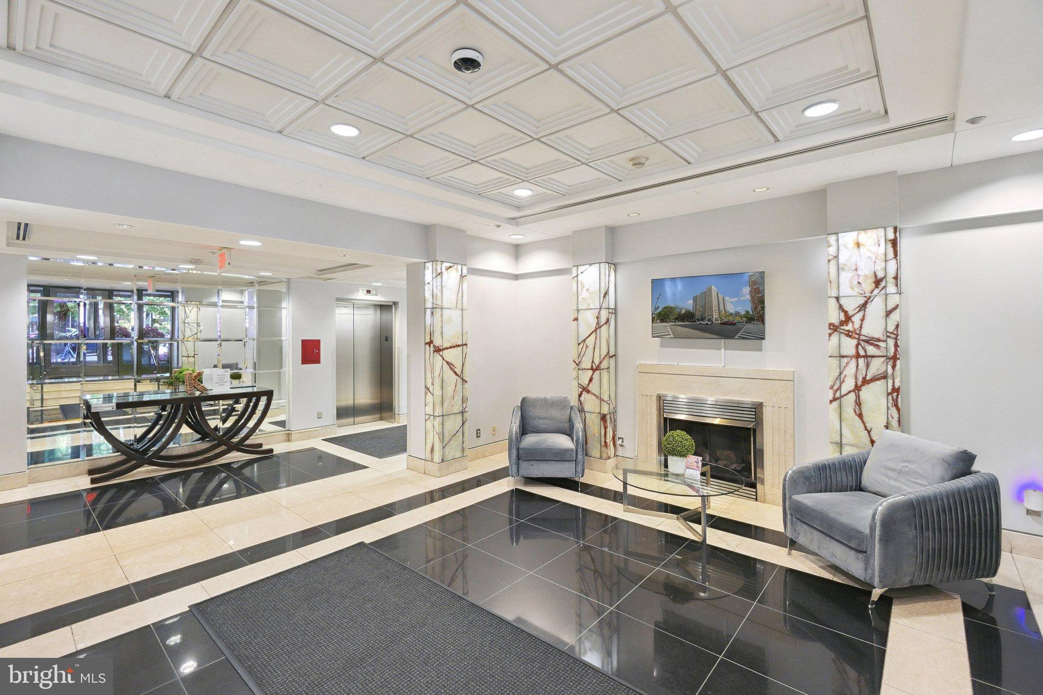 1150 K Street Northwest, Unit 1111 Washington, DC 20005 - Photo 20 of 36 a living room with furniture and a fireplace