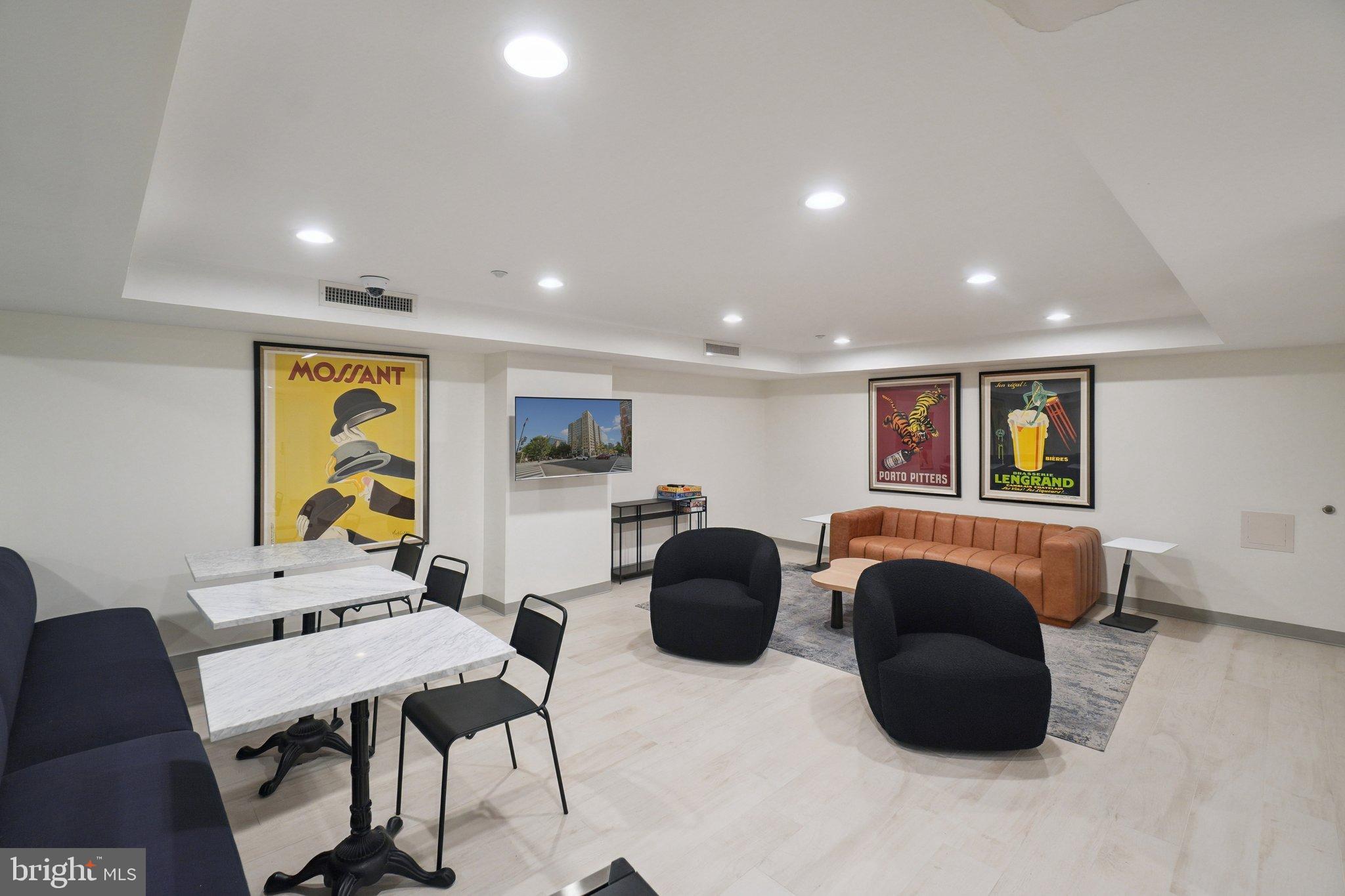 1150 K Street Northwest, Unit 1111 Washington, DC 20005 - Photo 25 of 36 a living room with furniture and a flat screen tv