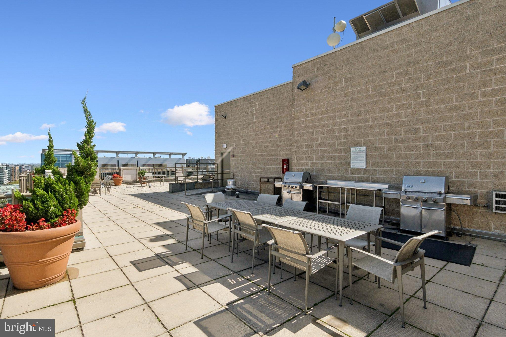 1150 K Street Northwest, Unit 1111 Washington, DC 20005 - Photo 27 of 36 a view of a patio with dining table and chairs