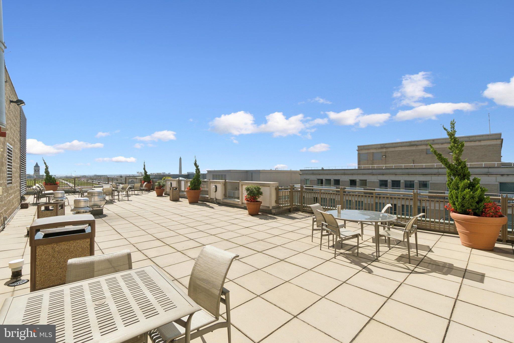 1150 K Street Northwest, Unit 1111 Washington, DC 20005 - Photo 29 of 36 a view of a terrace with furniture and a garden