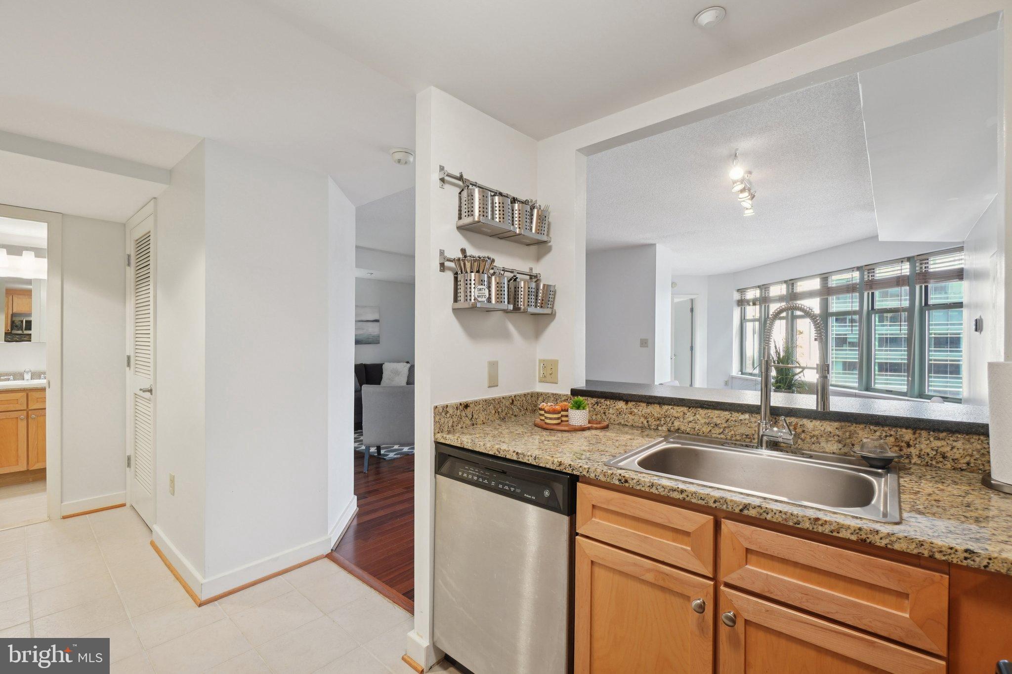 1150 K Street Northwest, Unit 1111 Washington, DC 20005 - Photo 5 of 36 a kitchen with stainless steel appliances granite countertop a sink and a refrigerator