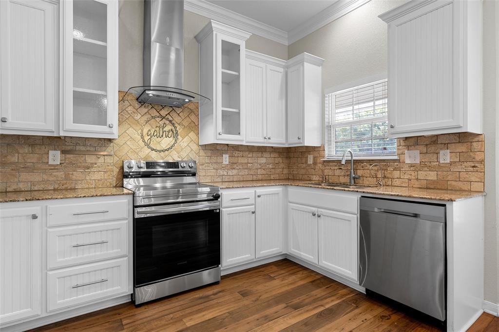 8224 Forest Ridge Drive Woodway, TX 76712 - Photo 11 of 38 a kitchen with a stove and white cabinets