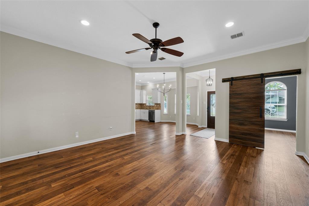 8224 Forest Ridge Drive Woodway, TX 76712 - Photo 12 of 38 a view of an empty room with wooden floor and a ceiling fan