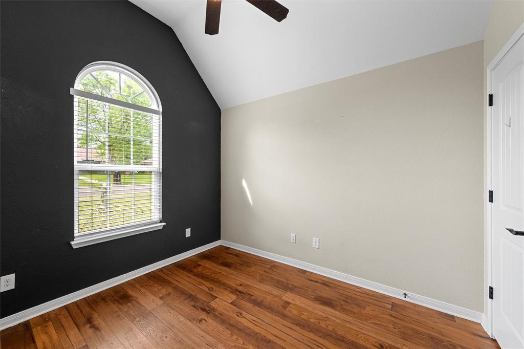 8224 Forest Ridge Drive Woodway, TX 76712 - Photo 14 of 38 wooden floor in an empty room with a window