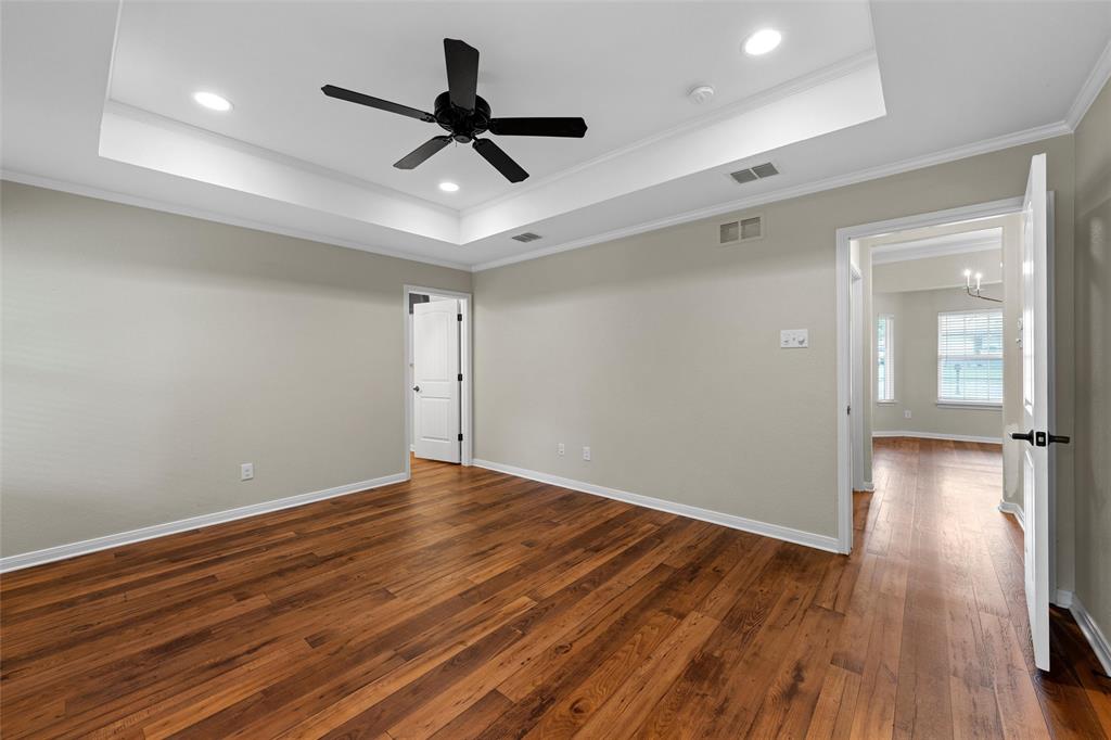 8224 Forest Ridge Drive Woodway, TX 76712 - Photo 16 of 38 a view of empty room with wooden floor and ceiling fan