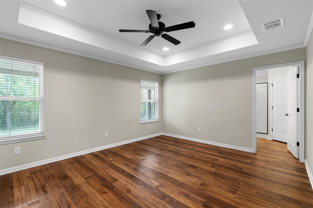 8224 Forest Ridge Drive Woodway, TX 76712 - Photo 17 of 38 a view of empty room with wooden floor and fan