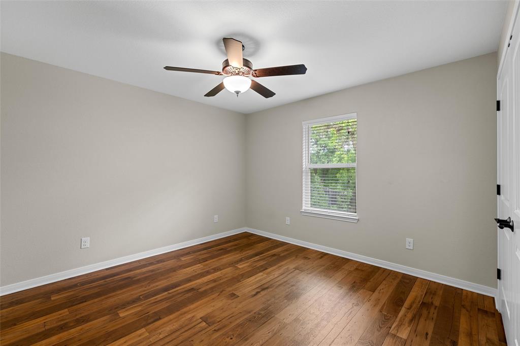8224 Forest Ridge Drive Woodway, TX 76712 - Photo 21 of 38 a view of empty room with wooden floor and fan