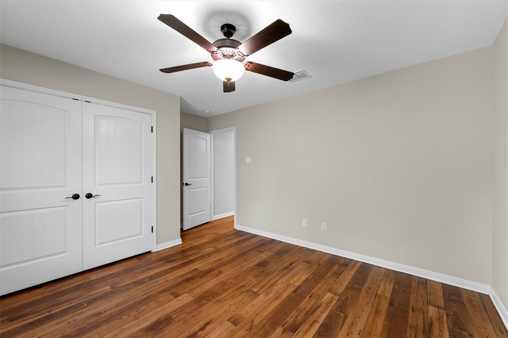 8224 Forest Ridge Drive Woodway, TX 76712 - Photo 22 of 38 an empty room with wooden floor and windows