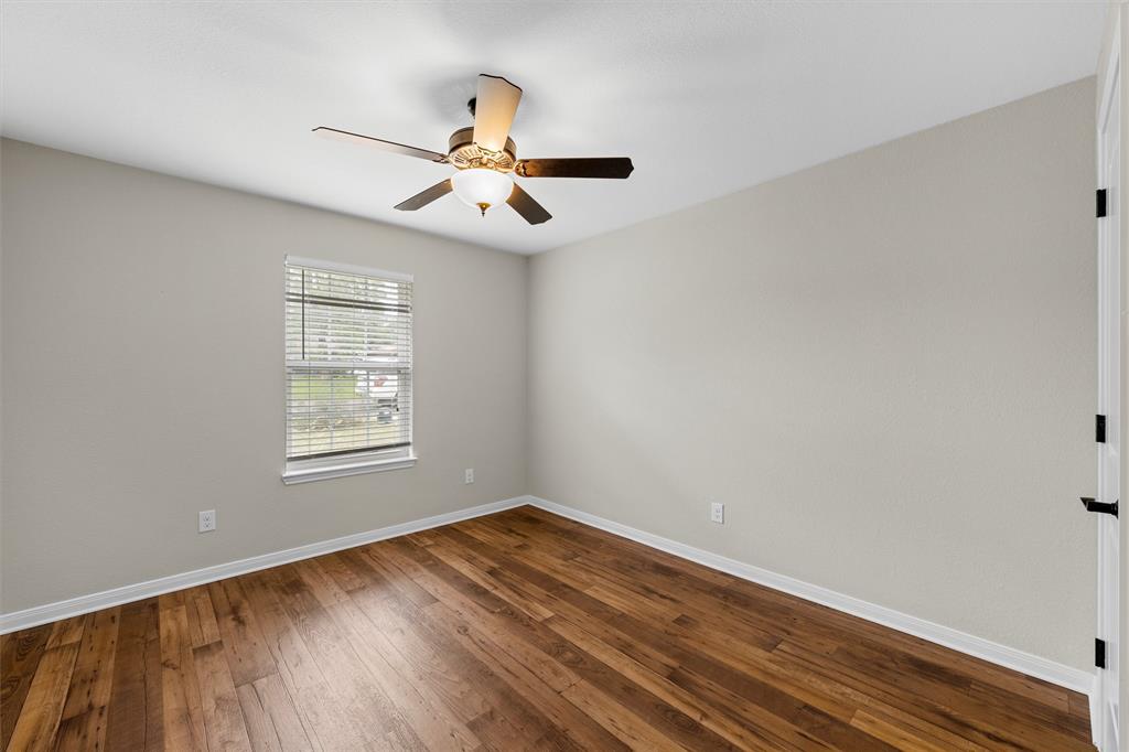8224 Forest Ridge Drive Woodway, TX 76712 - Photo 25 of 38 wooden floor in an empty room with a window