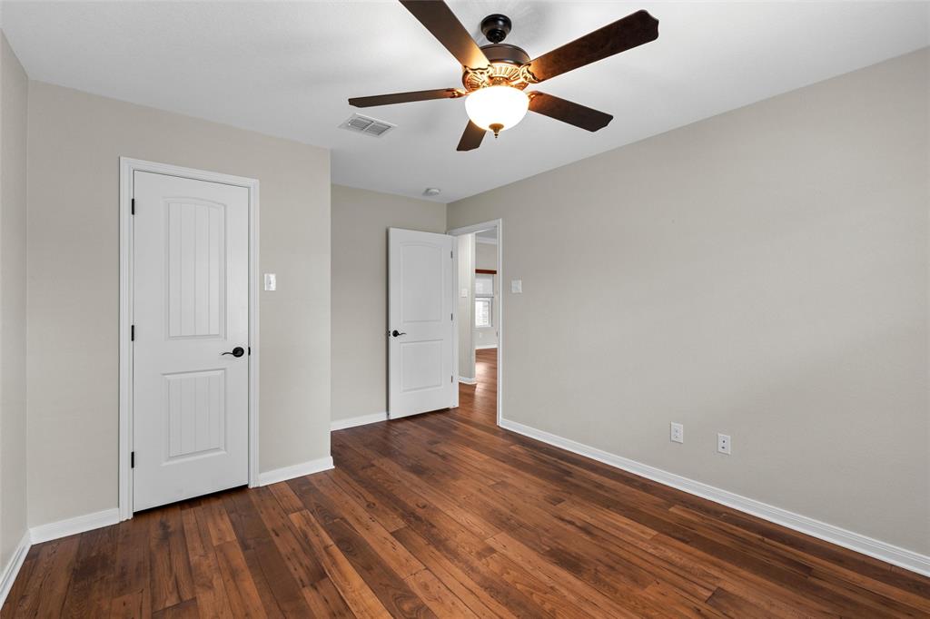 8224 Forest Ridge Drive Woodway, TX 76712 - Photo 26 of 38 an empty room with wooden floor and a ceiling fan