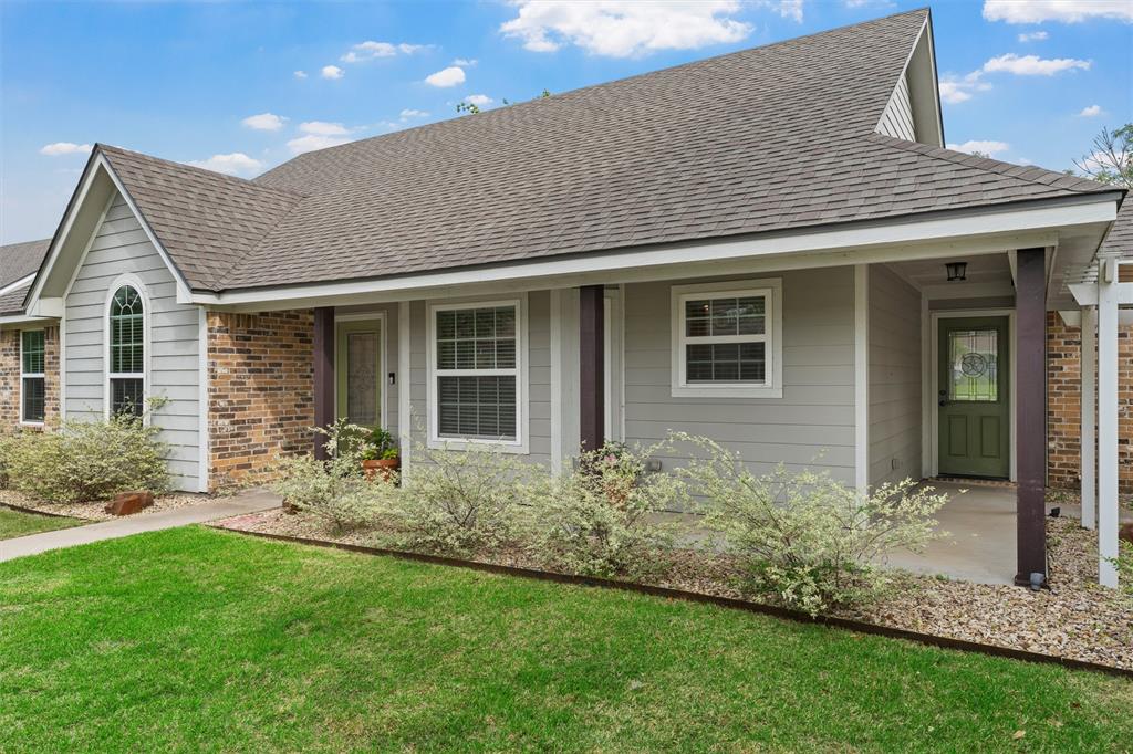 8224 Forest Ridge Drive Woodway, TX 76712 - Photo 3 of 38 a front view of a house with garden