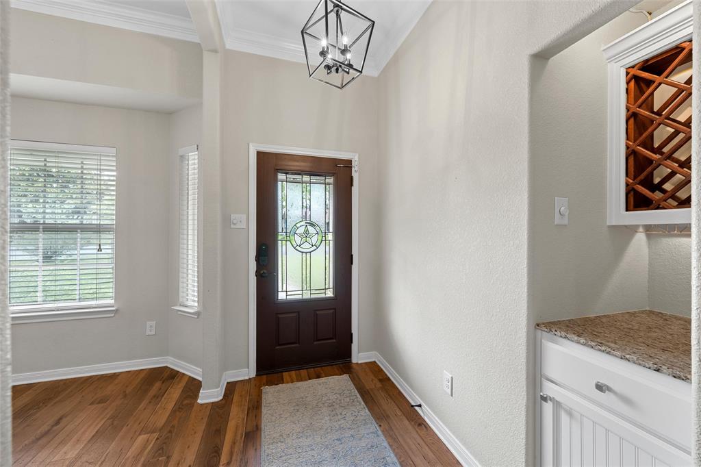 8224 Forest Ridge Drive Woodway, TX 76712 - Photo 4 of 38 a view of hallway with window and wooden floor