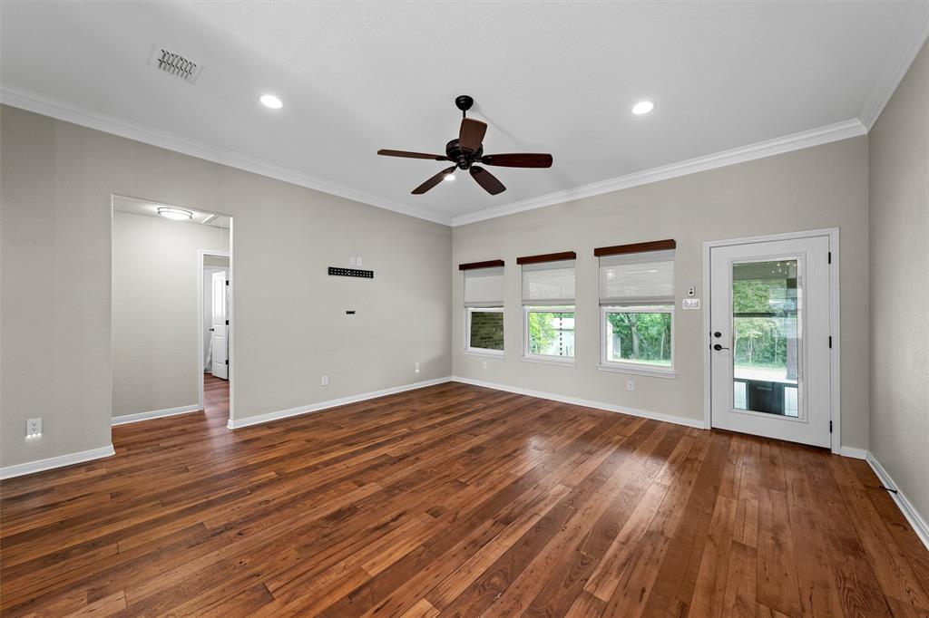 8224 Forest Ridge Drive Woodway, TX 76712 - Photo 5 of 38 a view of empty room with wooden floor and fan