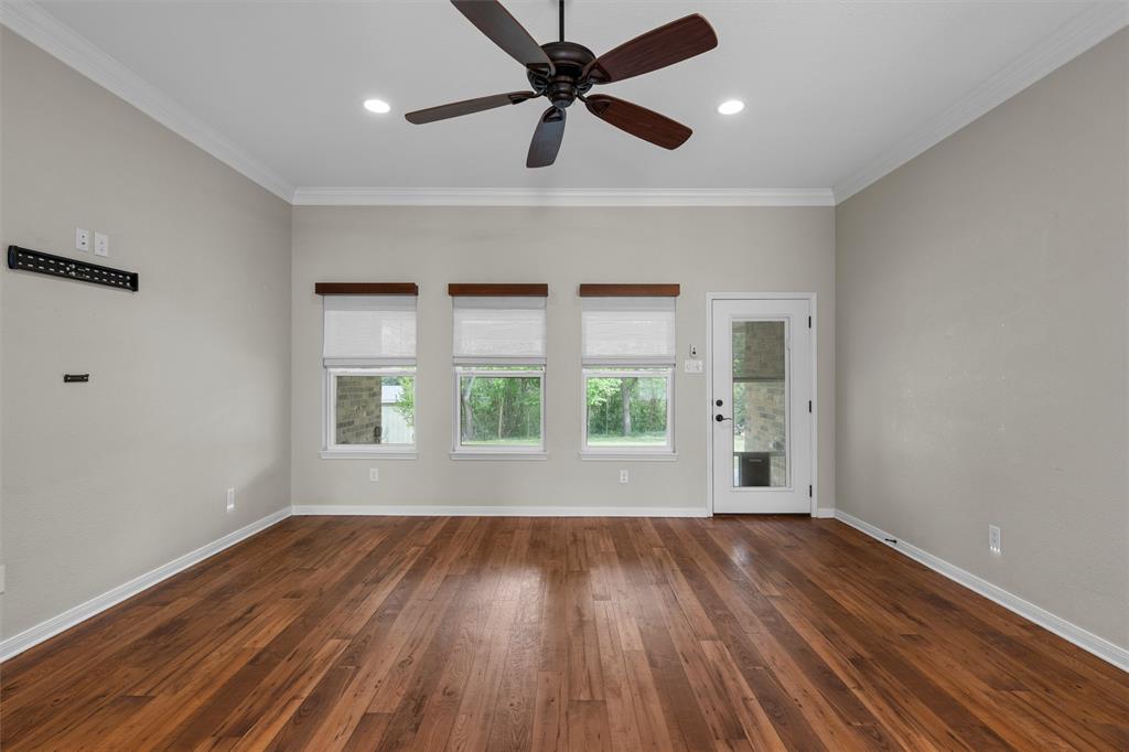 8224 Forest Ridge Drive Woodway, TX 76712 - Photo 7 of 38 a view of an empty room with wooden floor and a window