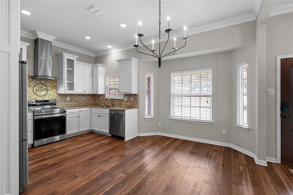 8224 Forest Ridge Drive Woodway, TX 76712 - Photo 8 of 38 a large kitchen with stainless steel appliances granite countertop a stove and a wooden floors