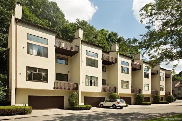 a car parked in front of a brick house