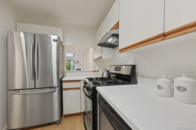 a bathroom with a toilet a sink a vanity and mirror