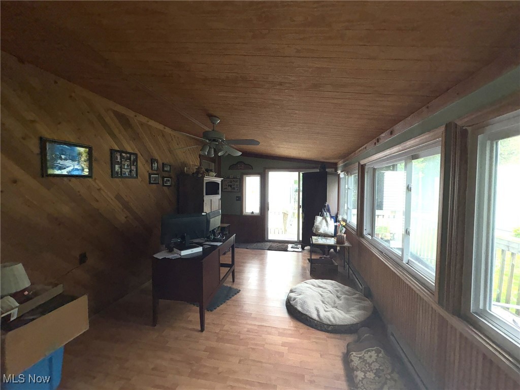 3181 Jaycox Road Avon, OH 44011 - Photo 17 of 48 Sunroom / solarium featuring healthy amount of natural light, wood ceiling, lofted ceiling, wooden walls, and wood finished floors
