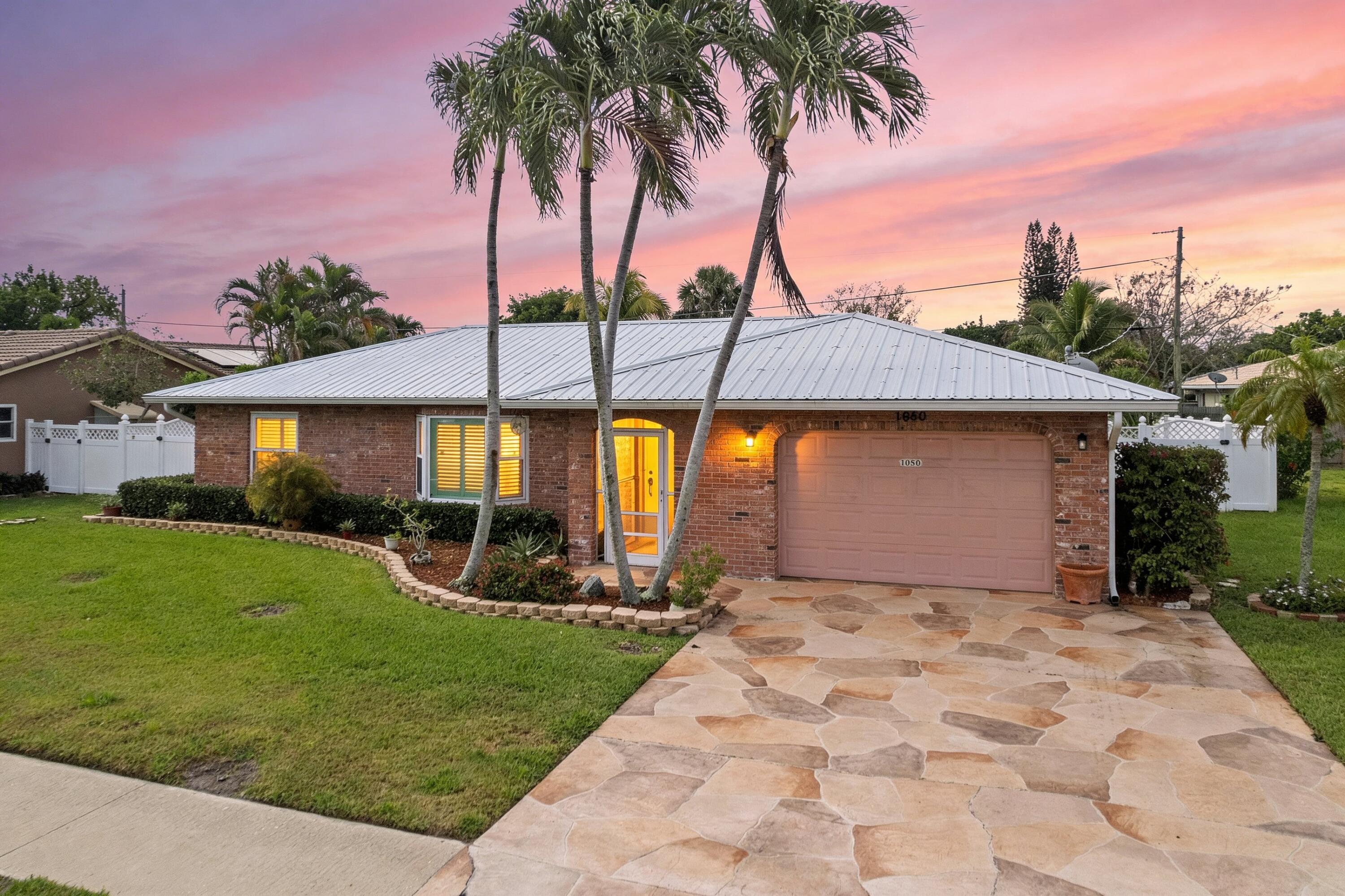 a front view of a house with a garden and yard