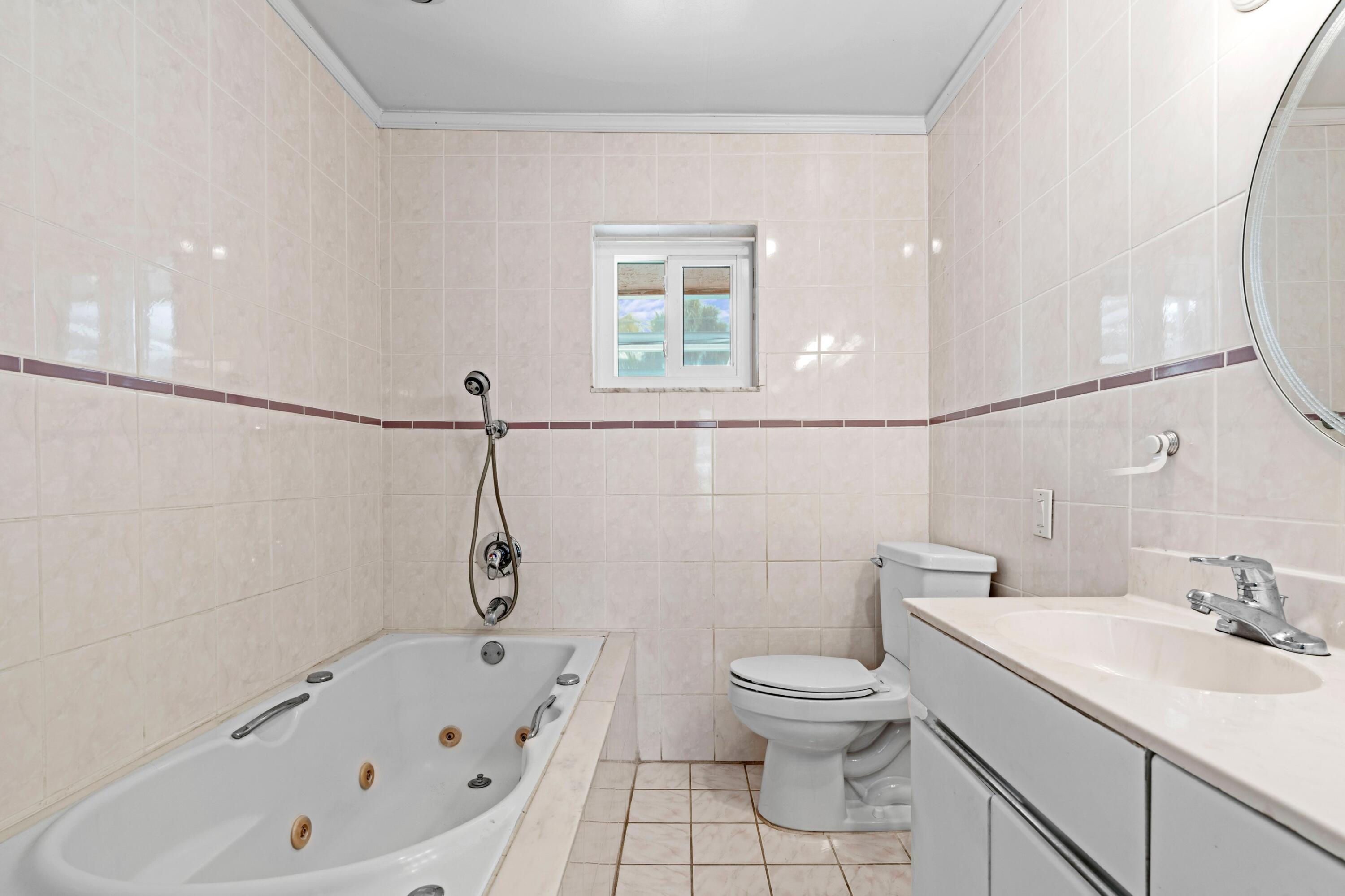 1640 Northwest 10th Street Boca Raton, FL 33486 - Photo 13 of 40 a bathroom with a sink a toilet and shower