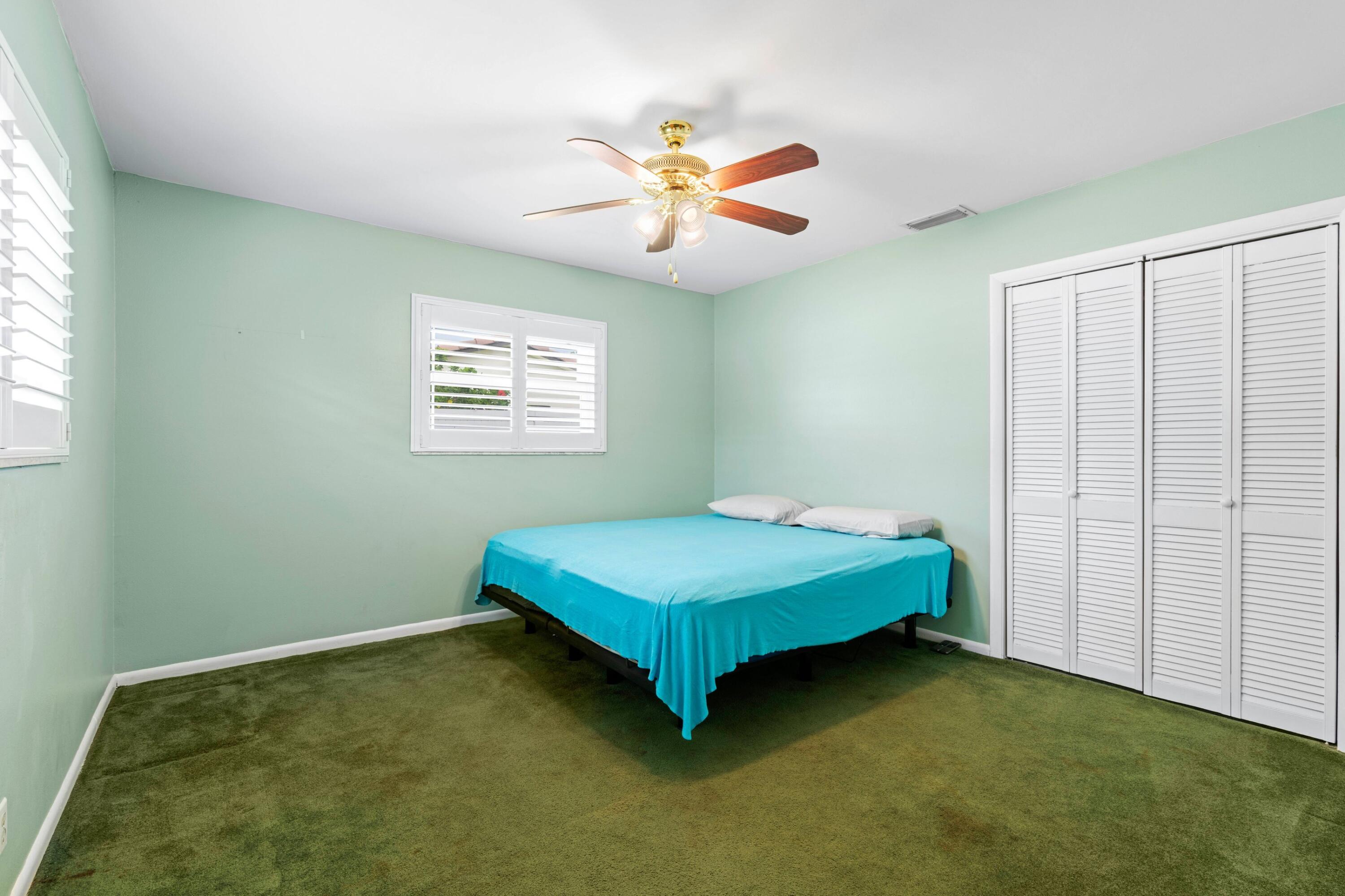 1640 Northwest 10th Street Boca Raton, FL 33486 - Photo 16 of 40 a room with a bed and a chandelier