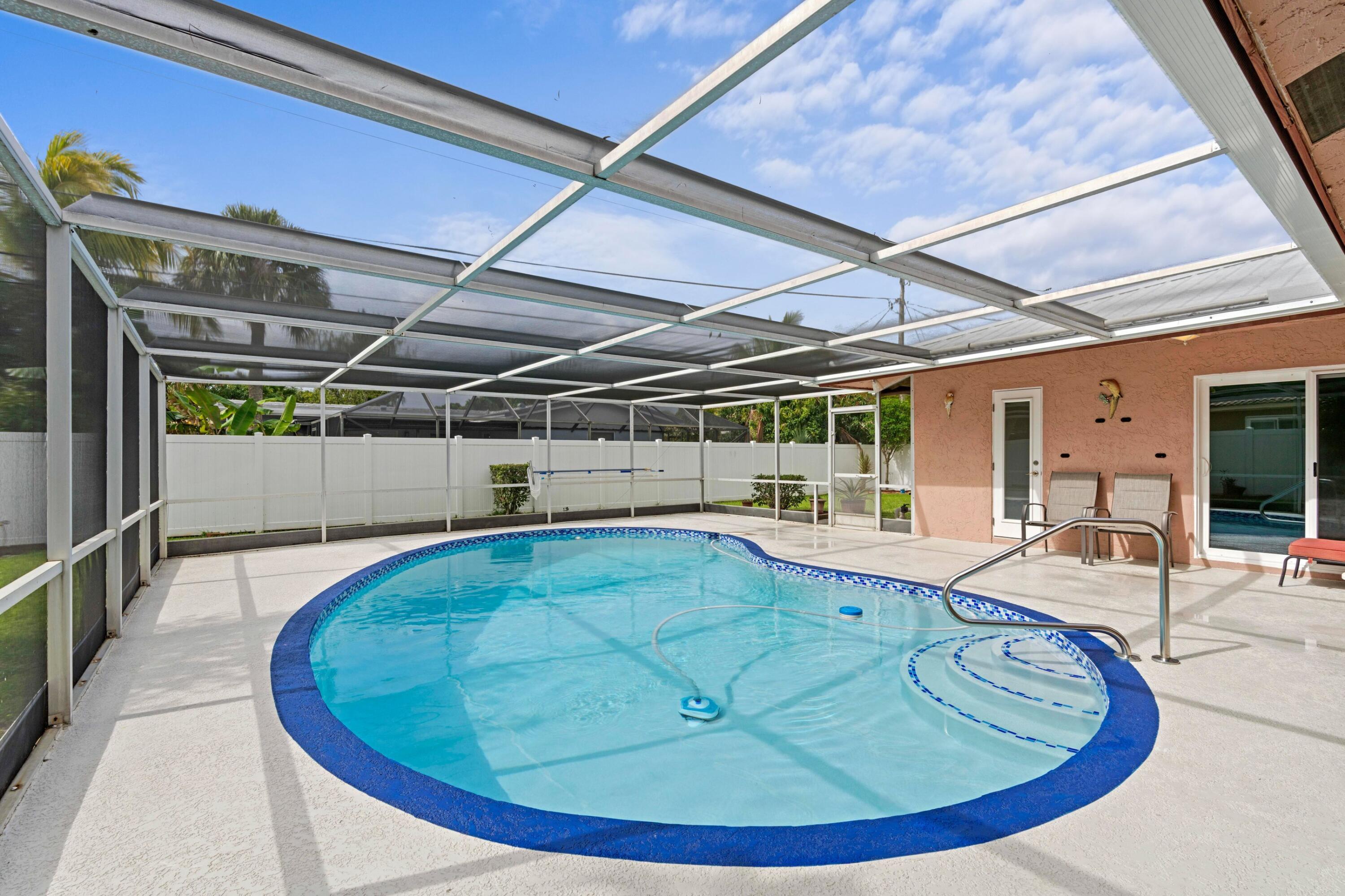 1640 Northwest 10th Street Boca Raton, FL 33486 - Photo 18 of 40 a view of a swimming pool with a patio