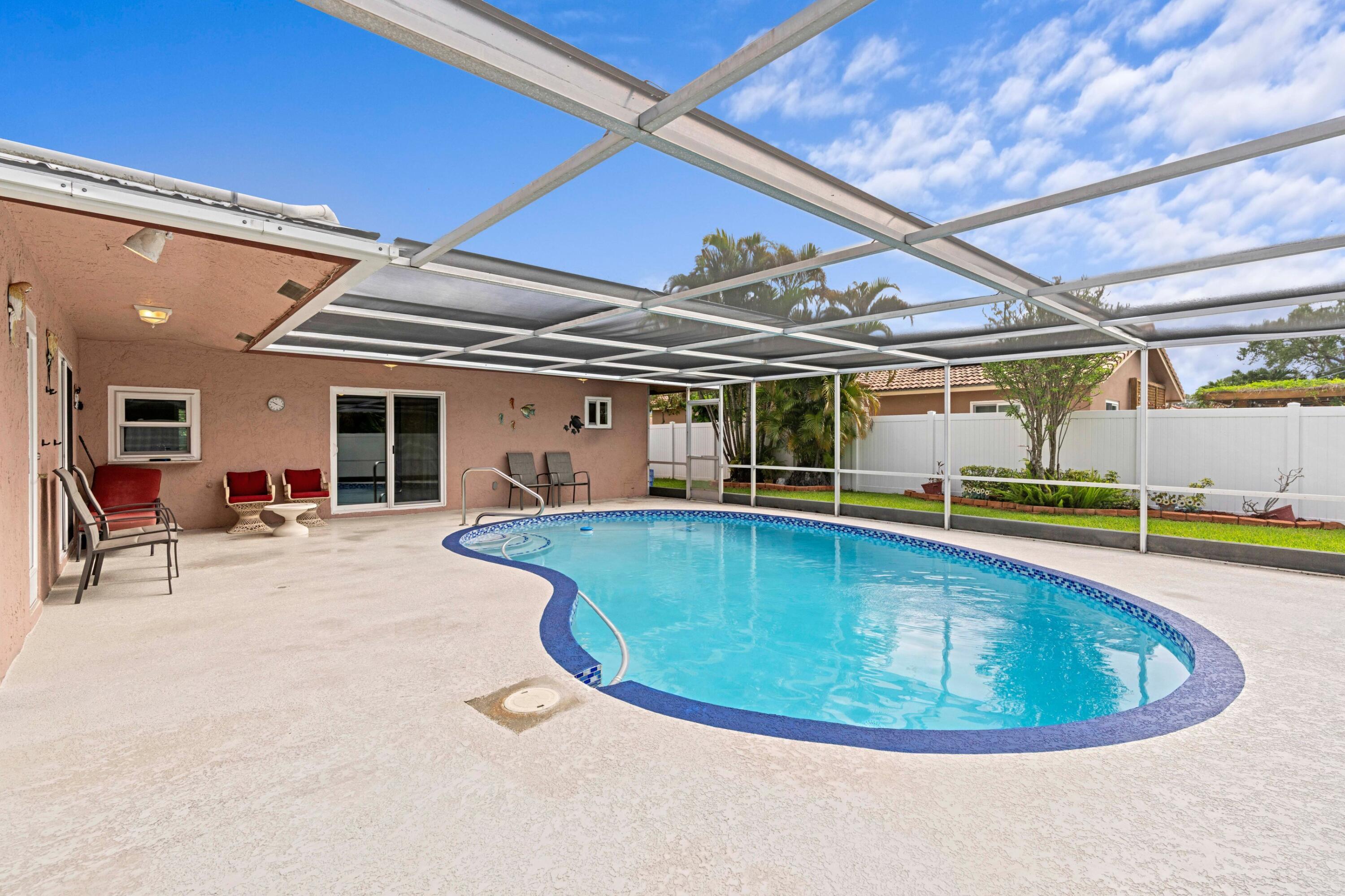 1640 Northwest 10th Street Boca Raton, FL 33486 - Photo 19 of 40 a view of a swimming pool with outdoor seating