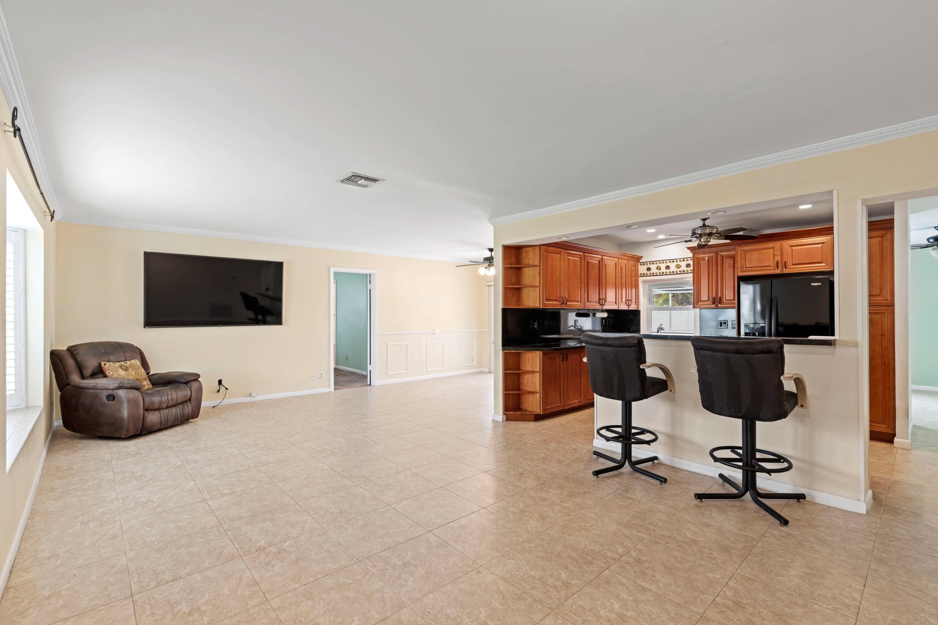 1640 Northwest 10th Street Boca Raton, FL 33486 - Photo 5 of 40 a view of a livingroom with workspace and a window