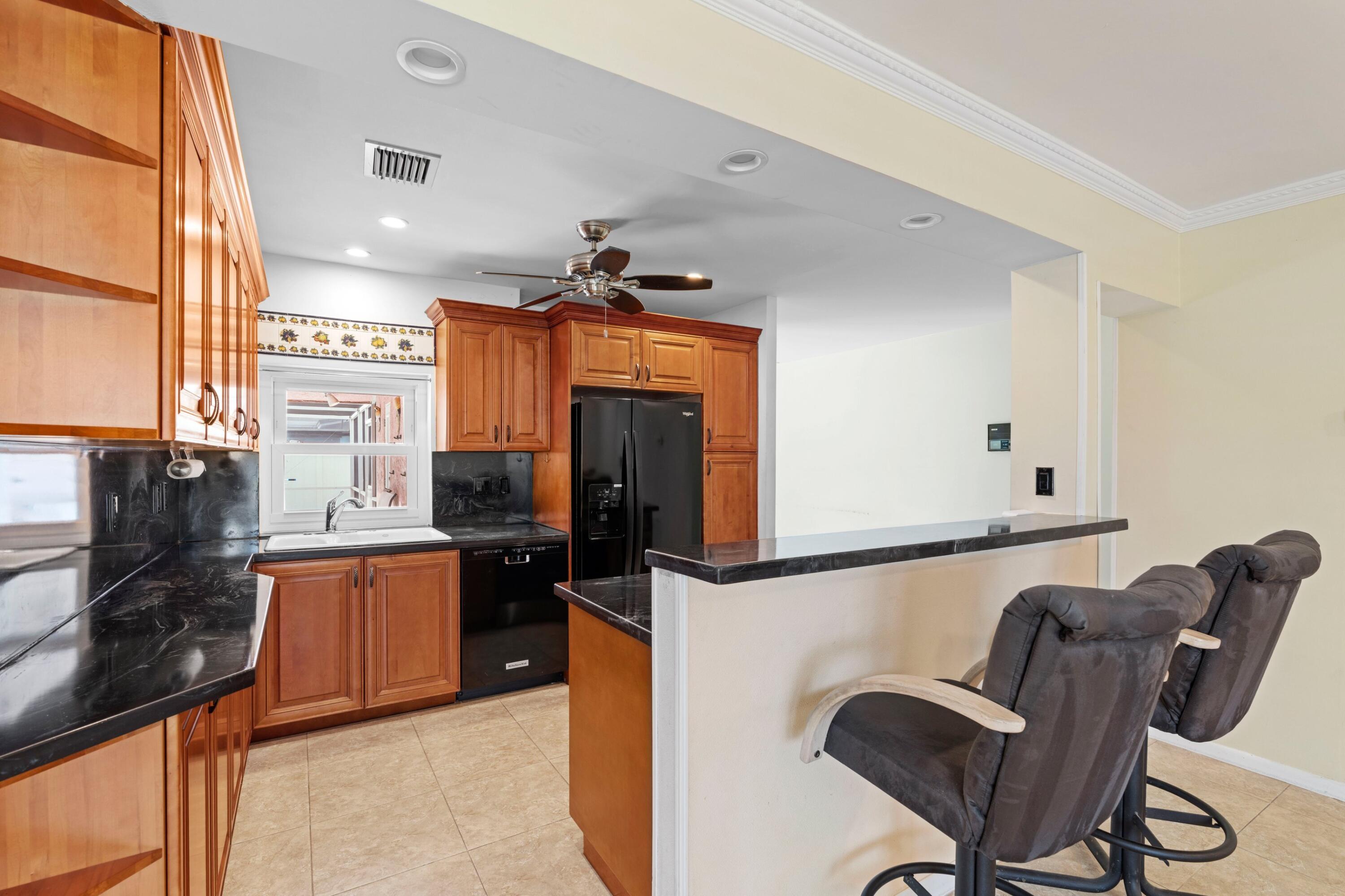 1640 Northwest 10th Street Boca Raton, FL 33486 - Photo 6 of 40 a kitchen with stainless steel appliances granite countertop a refrigerator and microwave